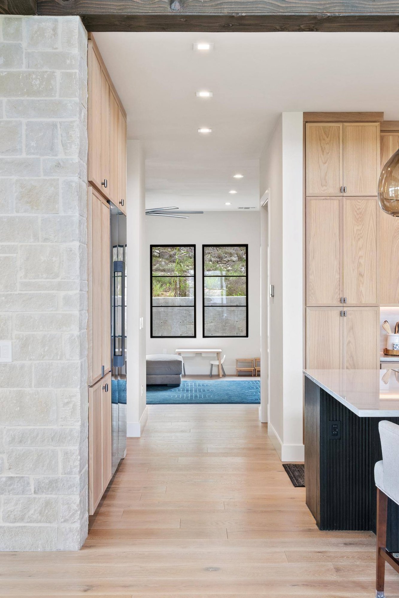 Custom home view from kitchen into entertainment area by J Angelo Design Build in Austin, Texas