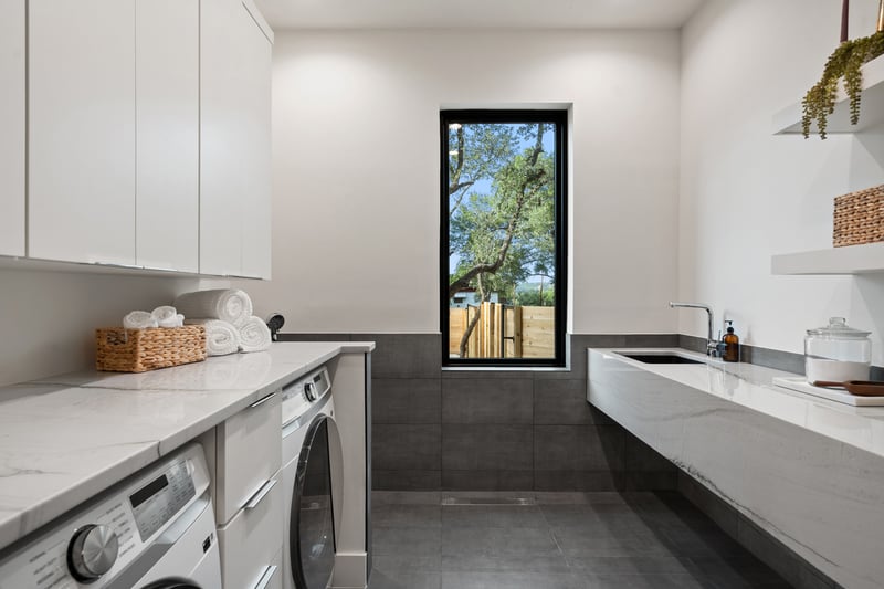 Laundry room with modern appliances and ample counter space in a custom home in Austin, TX by J. Angelo Design Build