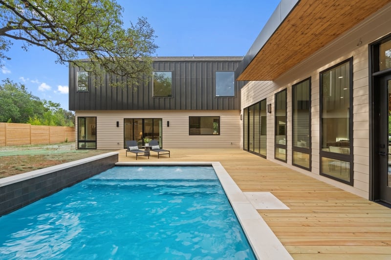Modern courtyard pool framed by natural wood deck in a custom home in Austin, TX by J. Angelo Design Build