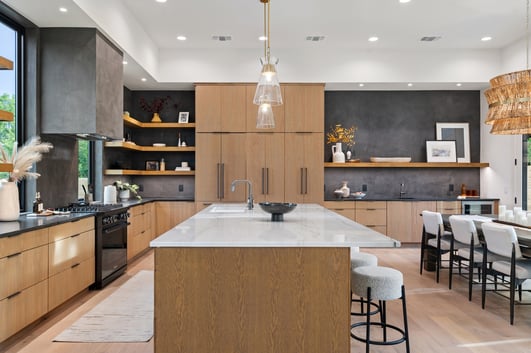 Open-concept kitchen design with modern lighting in a custom home in Austin, TX by J. Angelo Design Build
