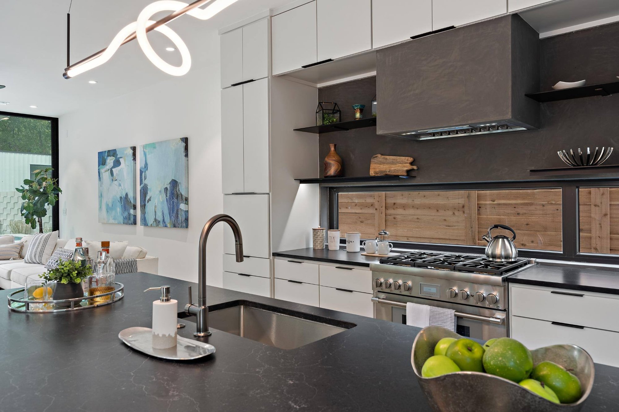 Remodeled kitchen with gas stove and natural light by J. Angelo Design Build