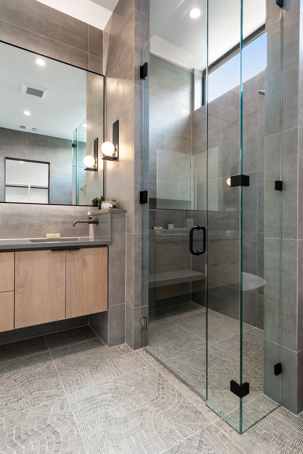 Custom bathroom featuring floating vanity and walk in shower