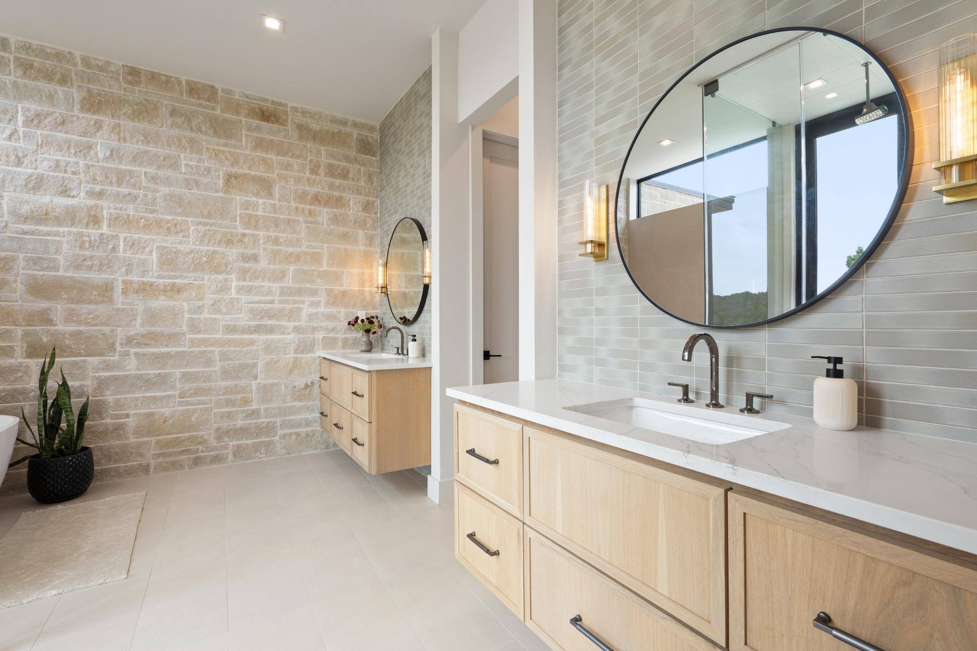 Master bathroom brick wall and view of both sink areas in custom home built in Austin, TX by J. Angelo Design Build