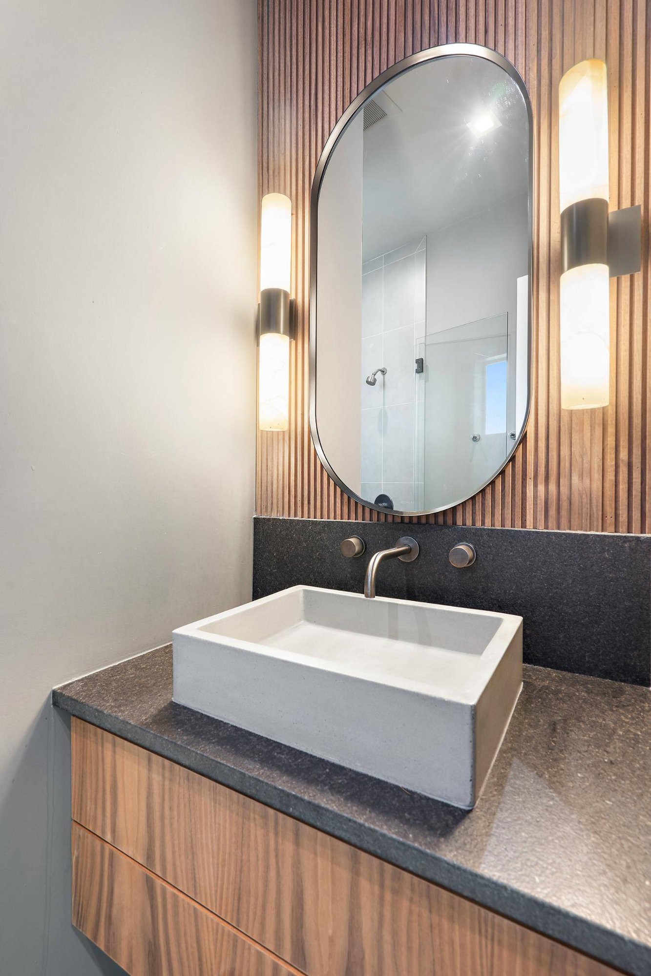 Bathroom with a contemporary vanity and rectangular sink in a custom home by J. Angelo Design Build in Southwest Austin, TX