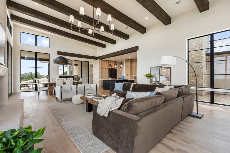 Living room into dining area with exposed beams in custom home by J. Angelo Design Build in Southwest Austin, TX