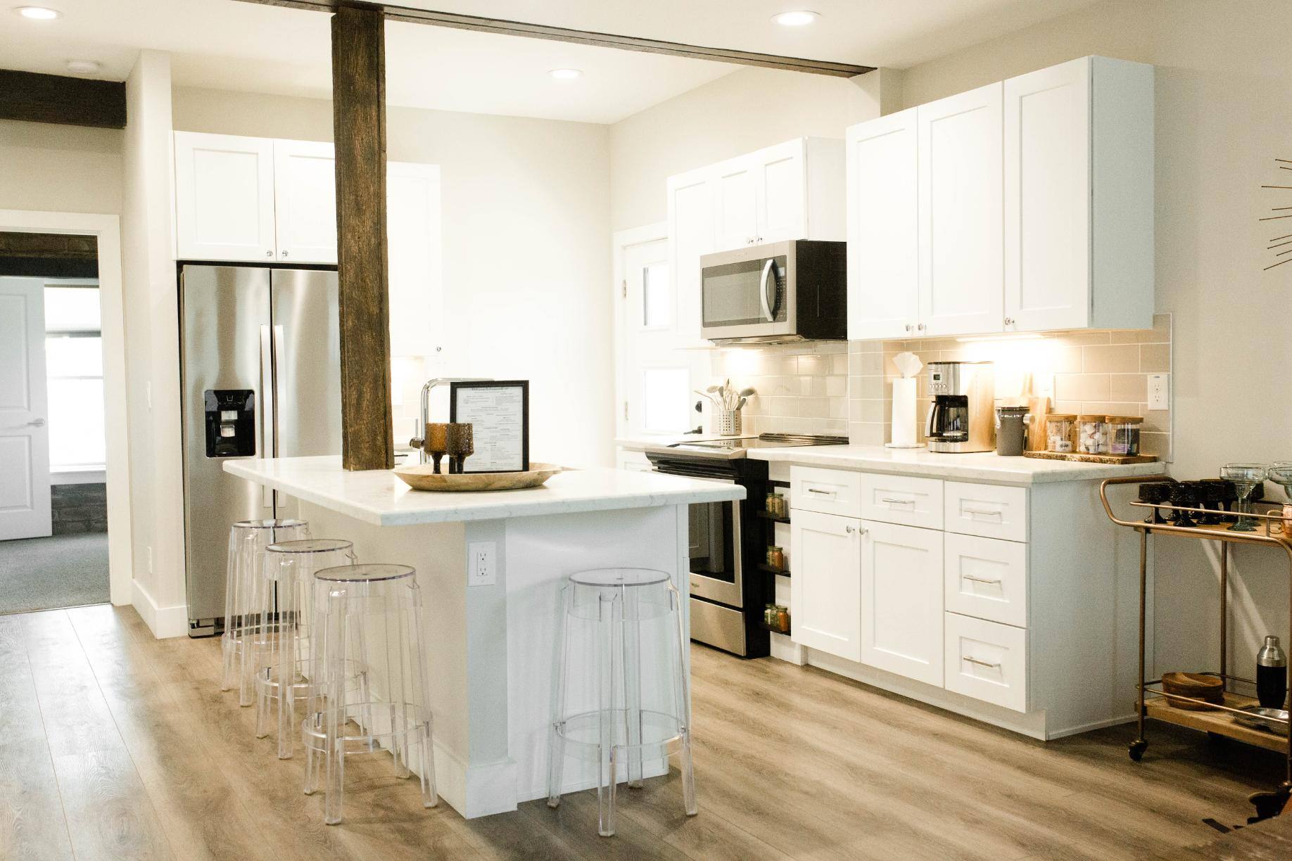 Remodeled kitchen with island and bar stools by J. Angelo Design Build