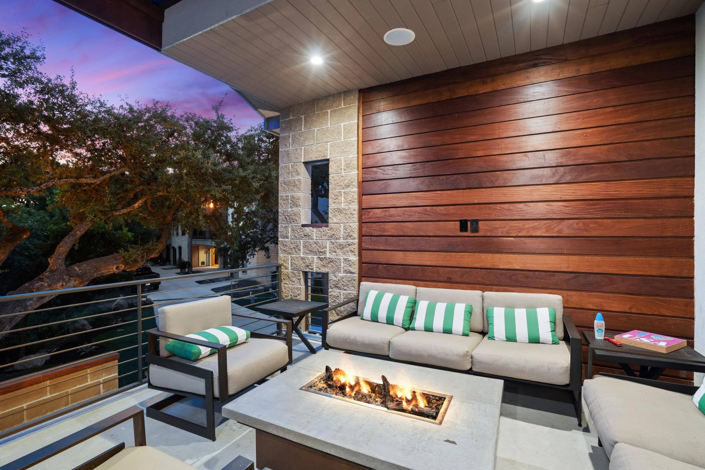 Back balcony overlooking the lake featuring a firepit and seating of custom home in Lake LBJ in Austin, TX by J. Angelo Design Build