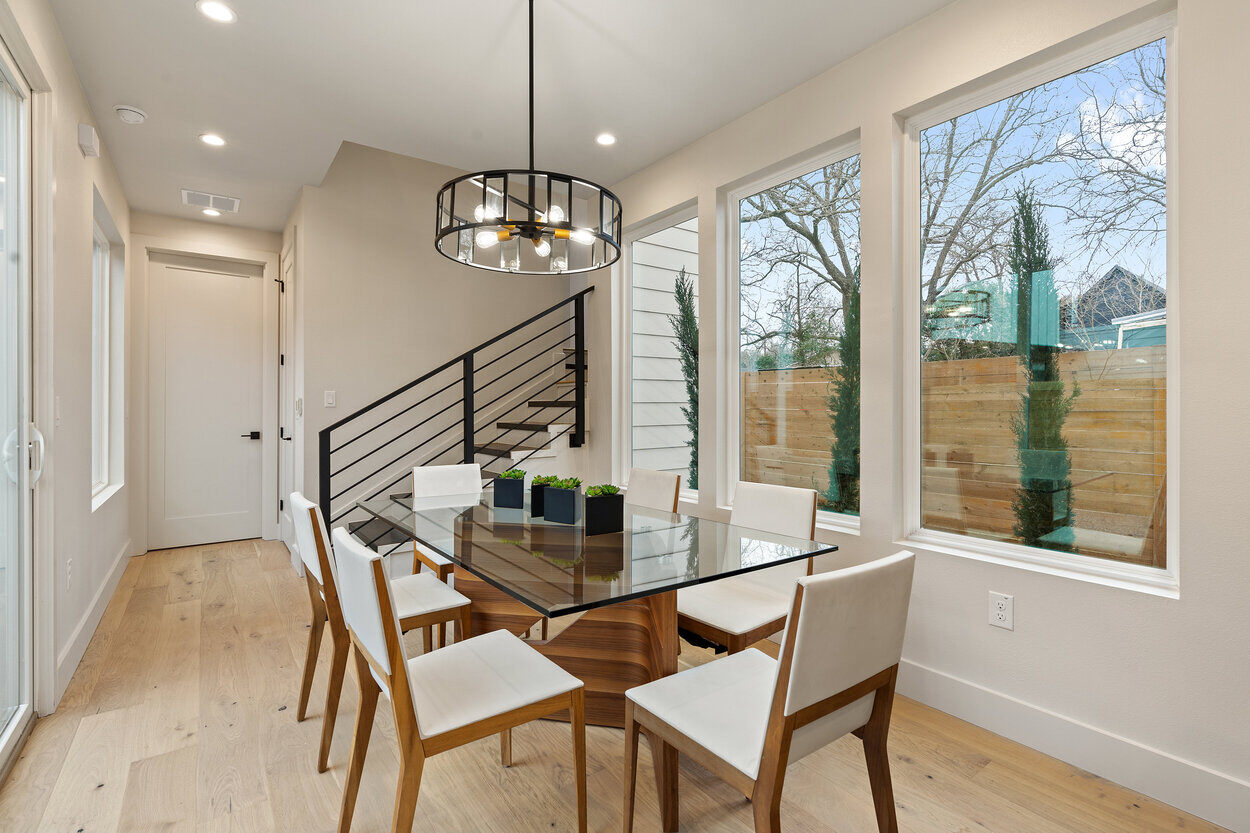 Dining table with a view of the backyard in a custom home build by J. Angelo Design Build in Austin, TX