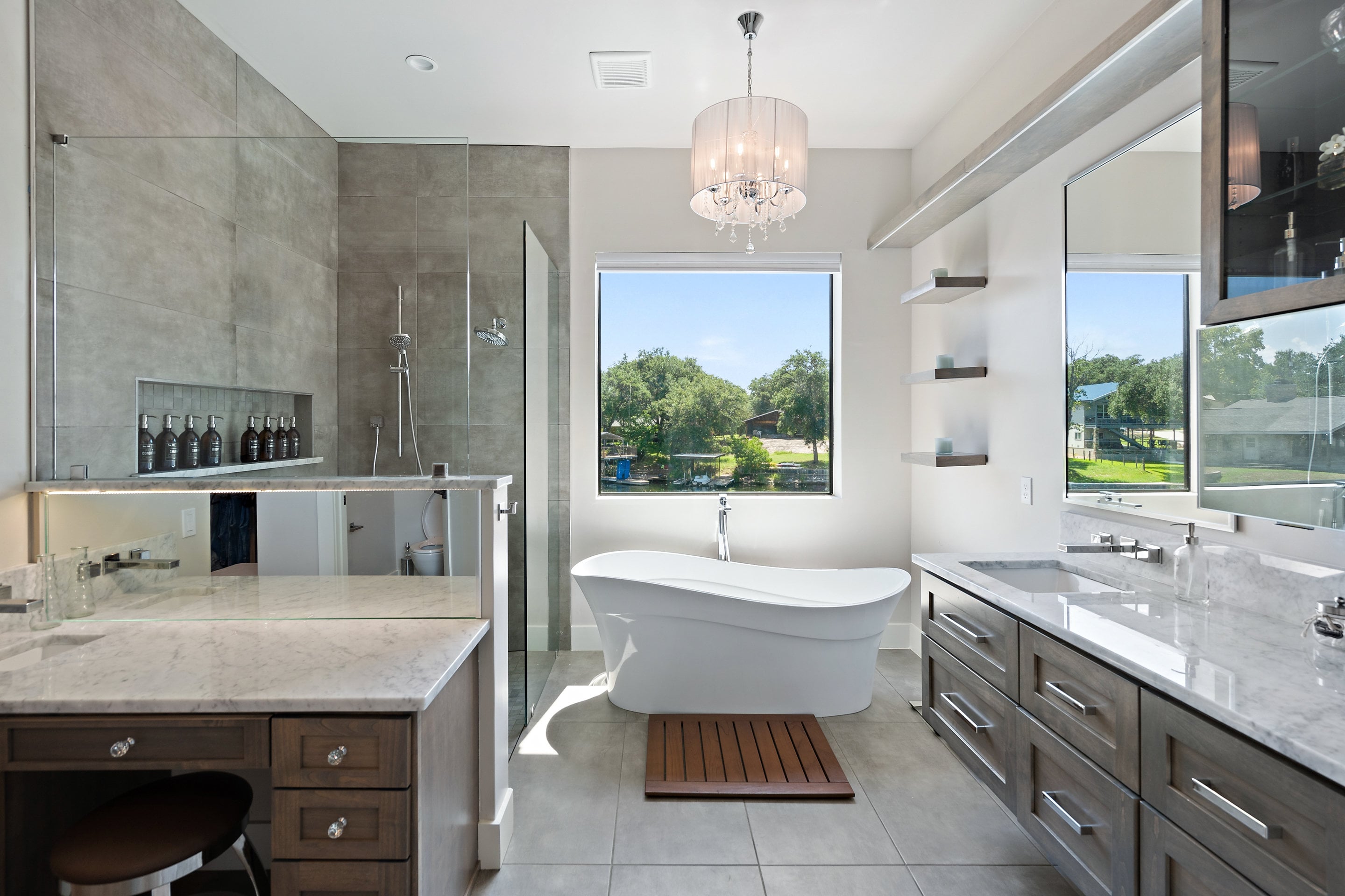 Custom bathroom with walk-in shower and window-front bathtub by J. Angelo Design Build