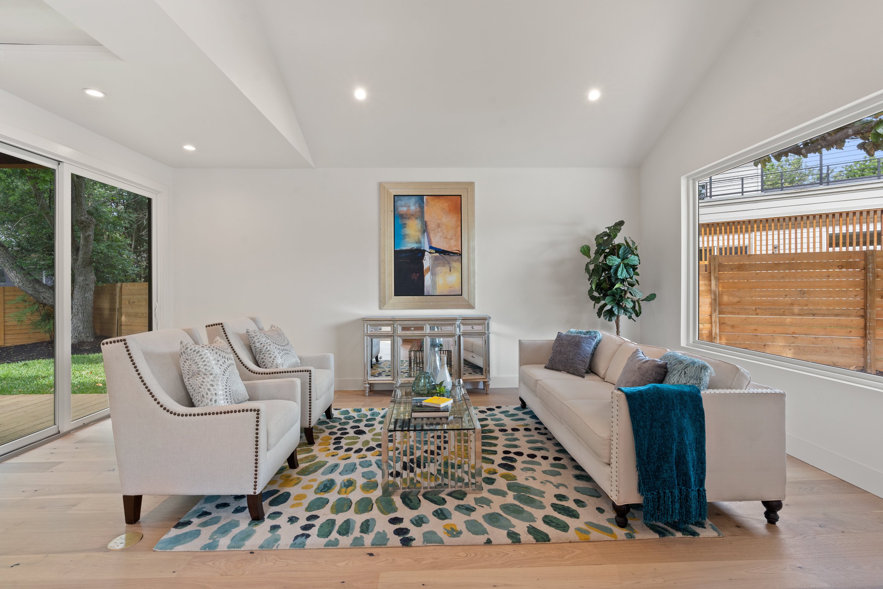 Custom living room with large window and sliding doors by J. Angelo Design Build in Austin, Texas