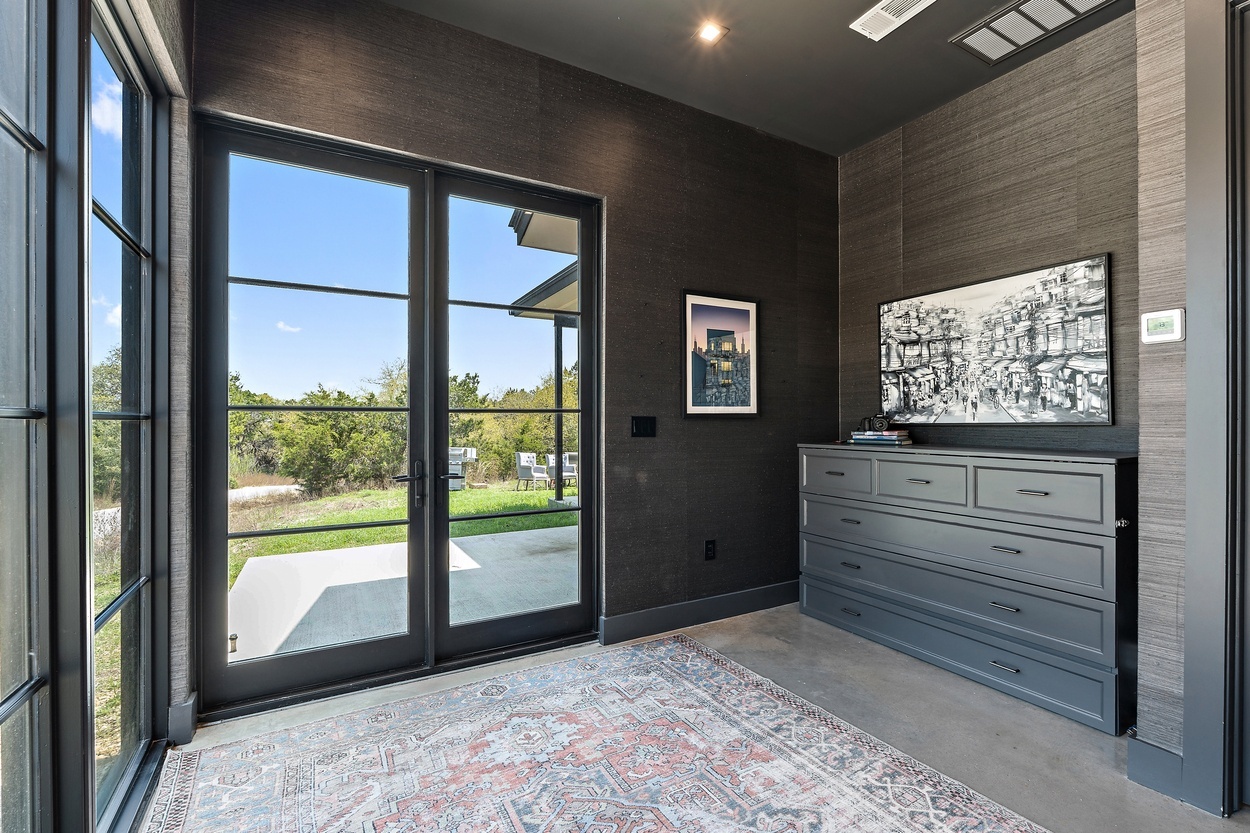 Modern office nook in a detached casita by J. Angelo Design Build in Austin, TX with natural light and scenic views