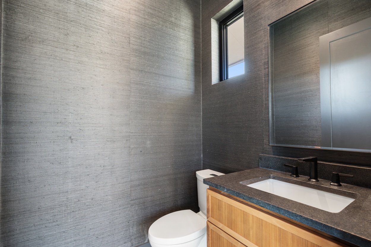 Powder room with a minimalist design in a detached casita office by J. Angelo Design Build in Austin, TX