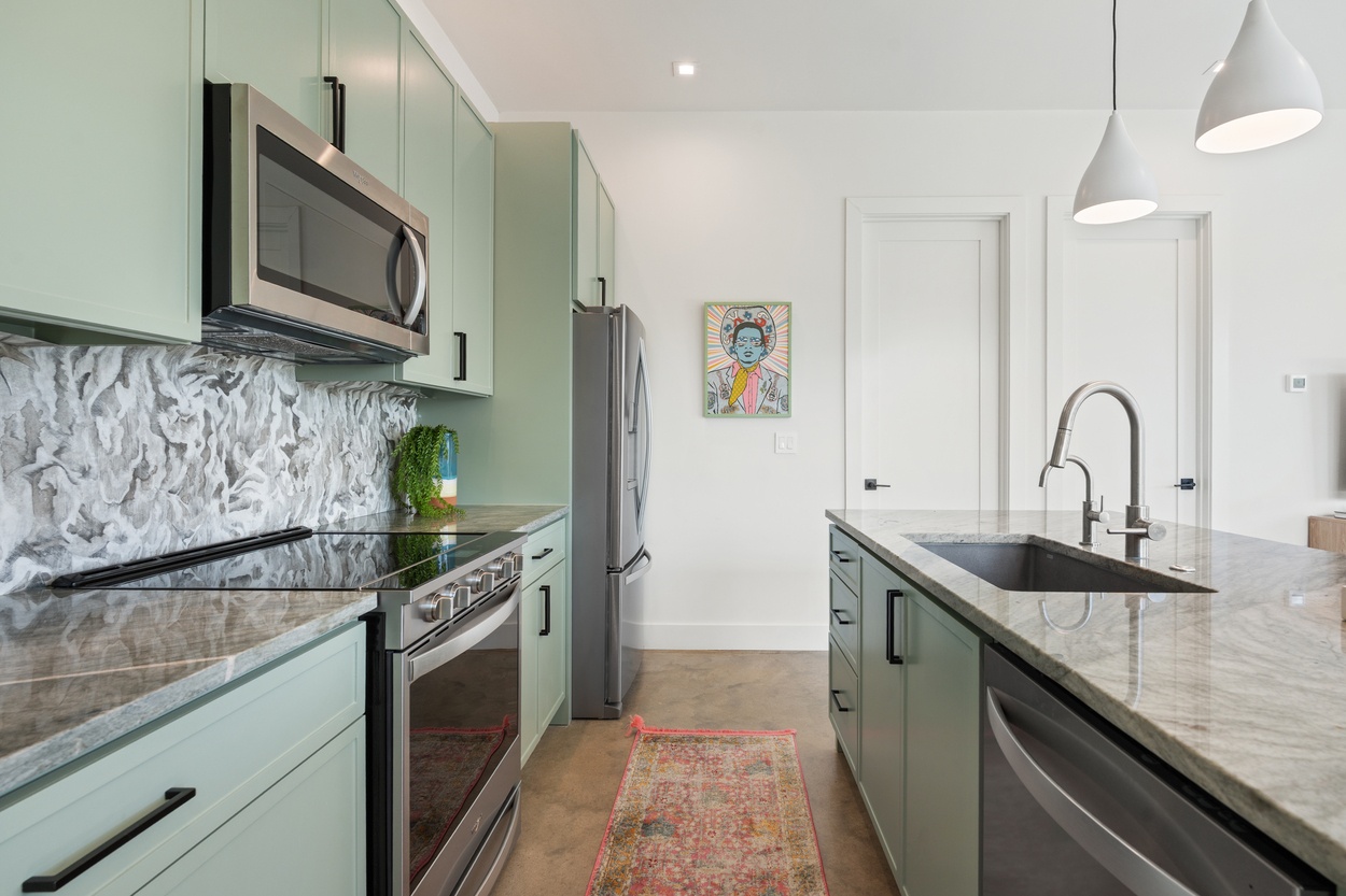 Side view of kitchen showing functional layout and custom finishes in a detached casita by J. Angelo Design Build in Austin, TX