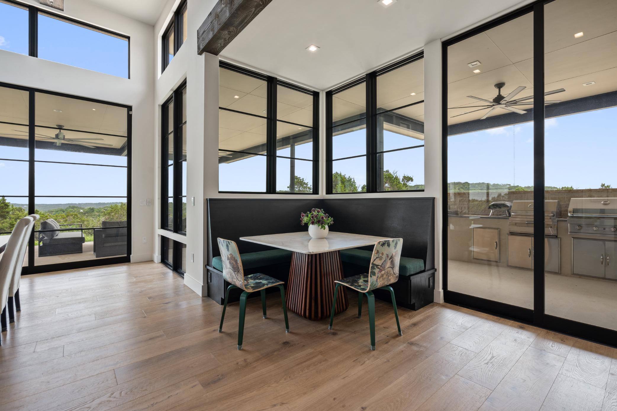 Custom homes breakfast area dining nook and large windows by J. Angelo Design Build in Southwest Austin, TX