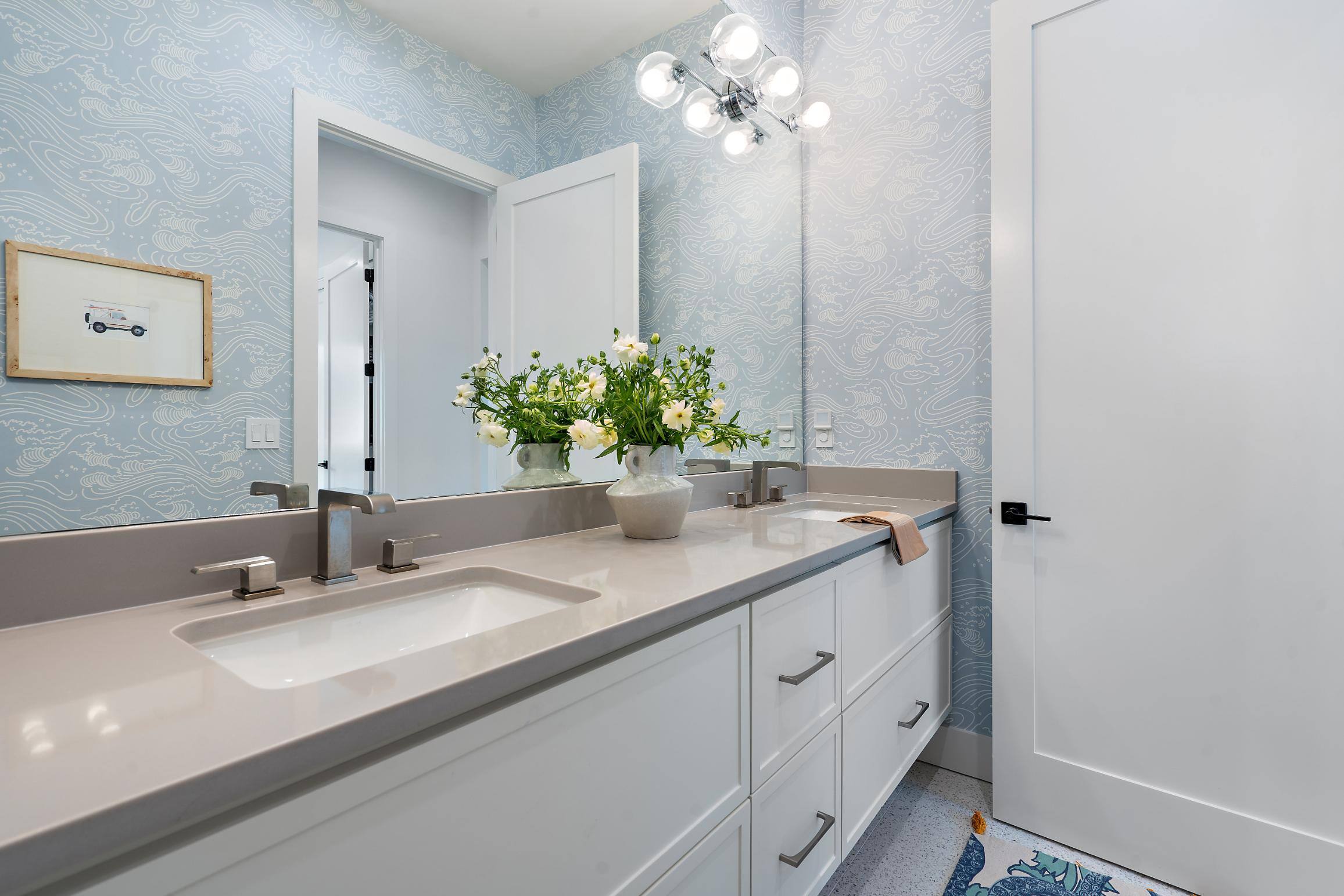 Double vanity bathroom with elegant floral decor in a custom home by J. Angelo Design Build in Southwest Austin, TX