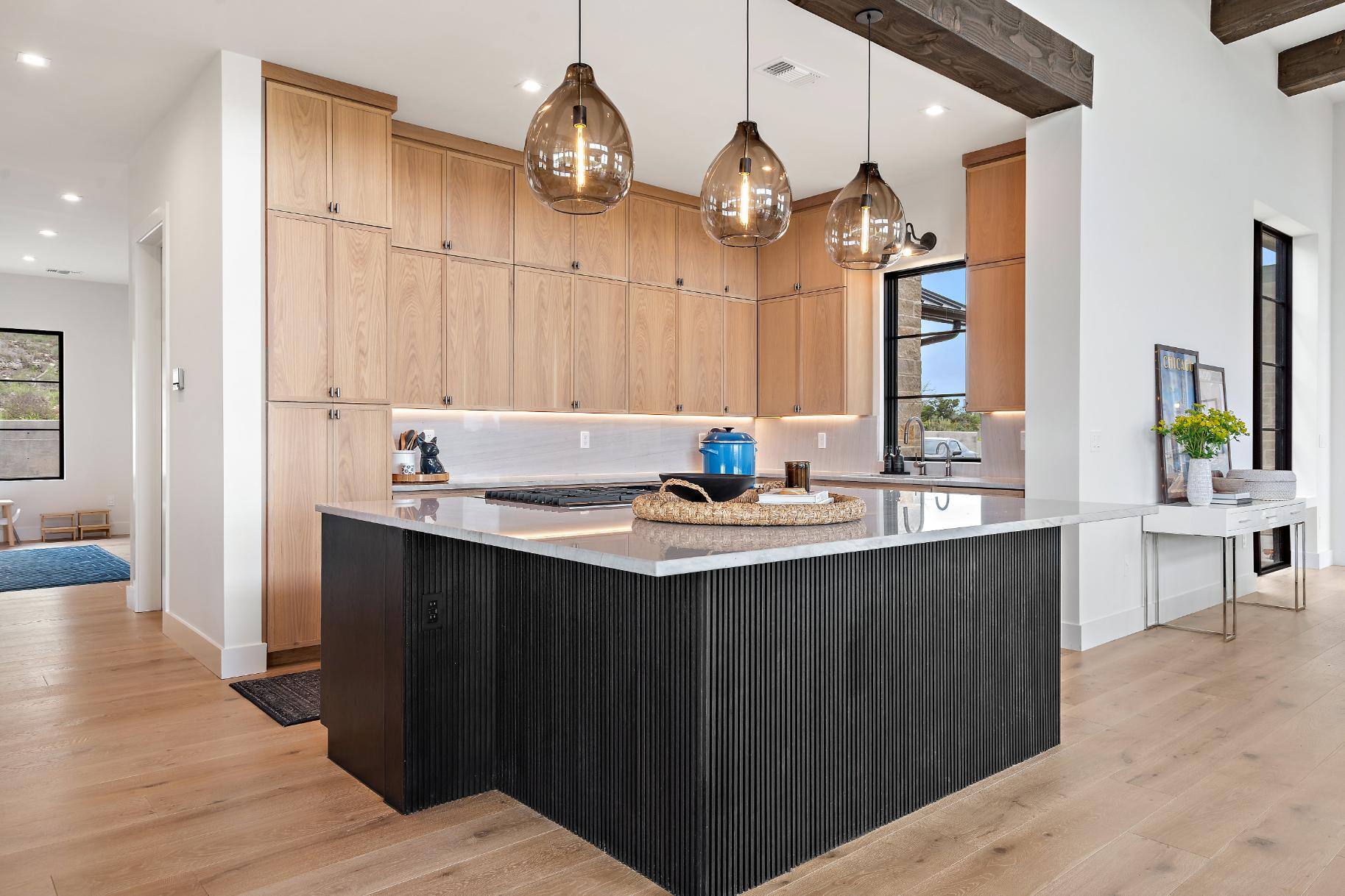 Kitchen area with large kitchen island in custom home built in Austin, TX by J. Angelo Design Build