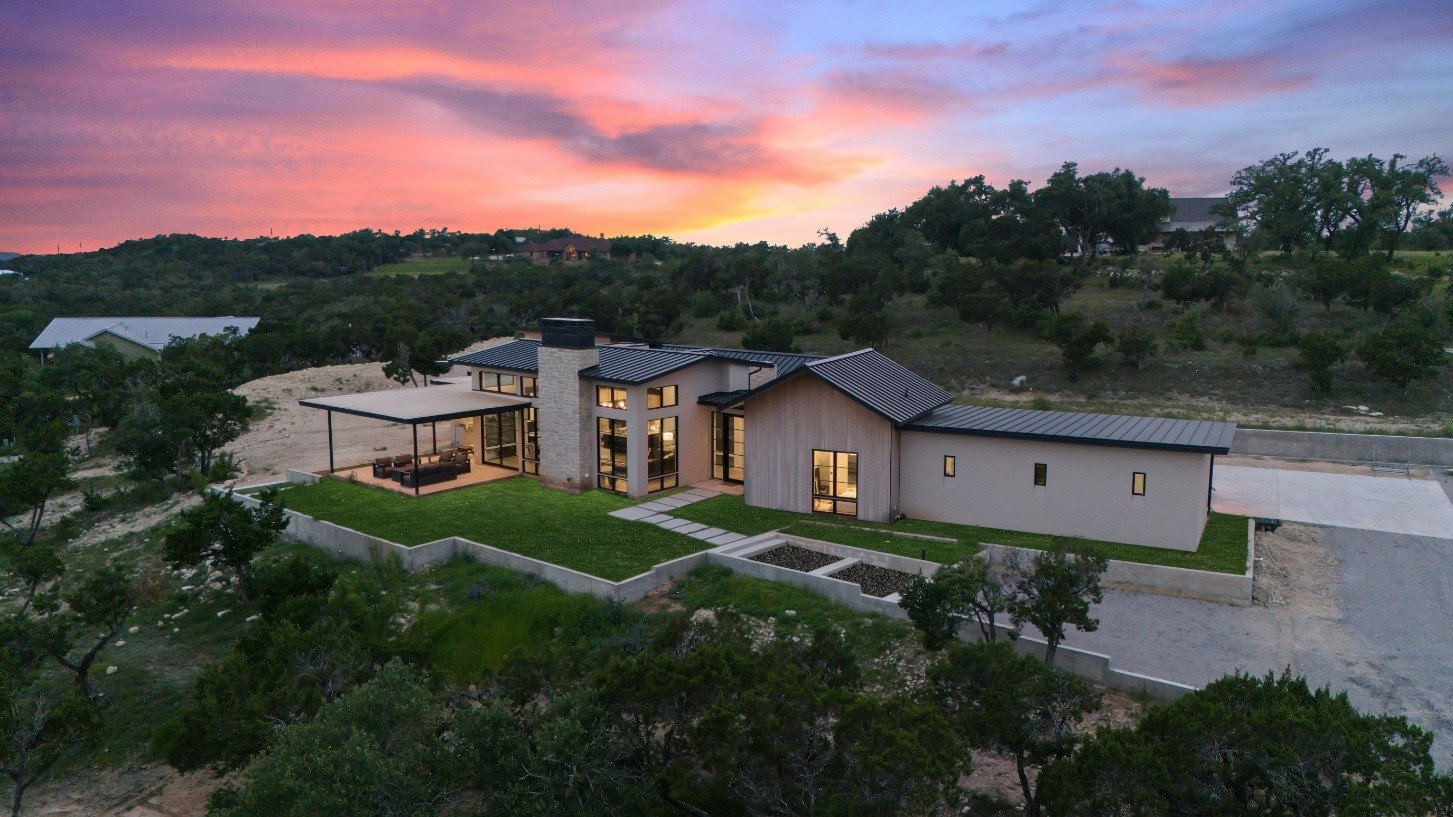 Custom-built home by J. Angelo Design Build in Southwest Austin, TX, illuminated during dusk with stunning outdoor space