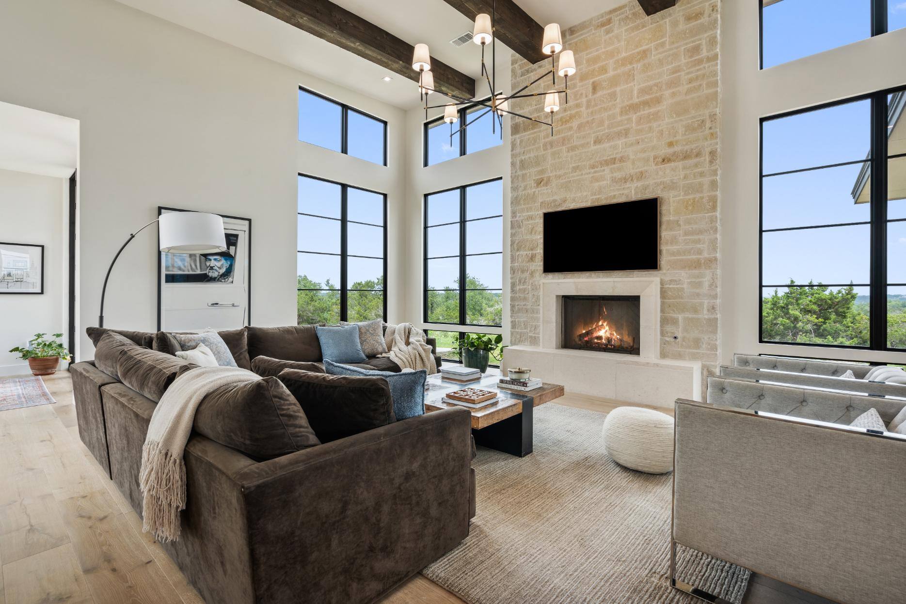 Open-concept living area with high ceilings and large windows in a custom home by J. Angelo Design Build in Southwest Austin, TX