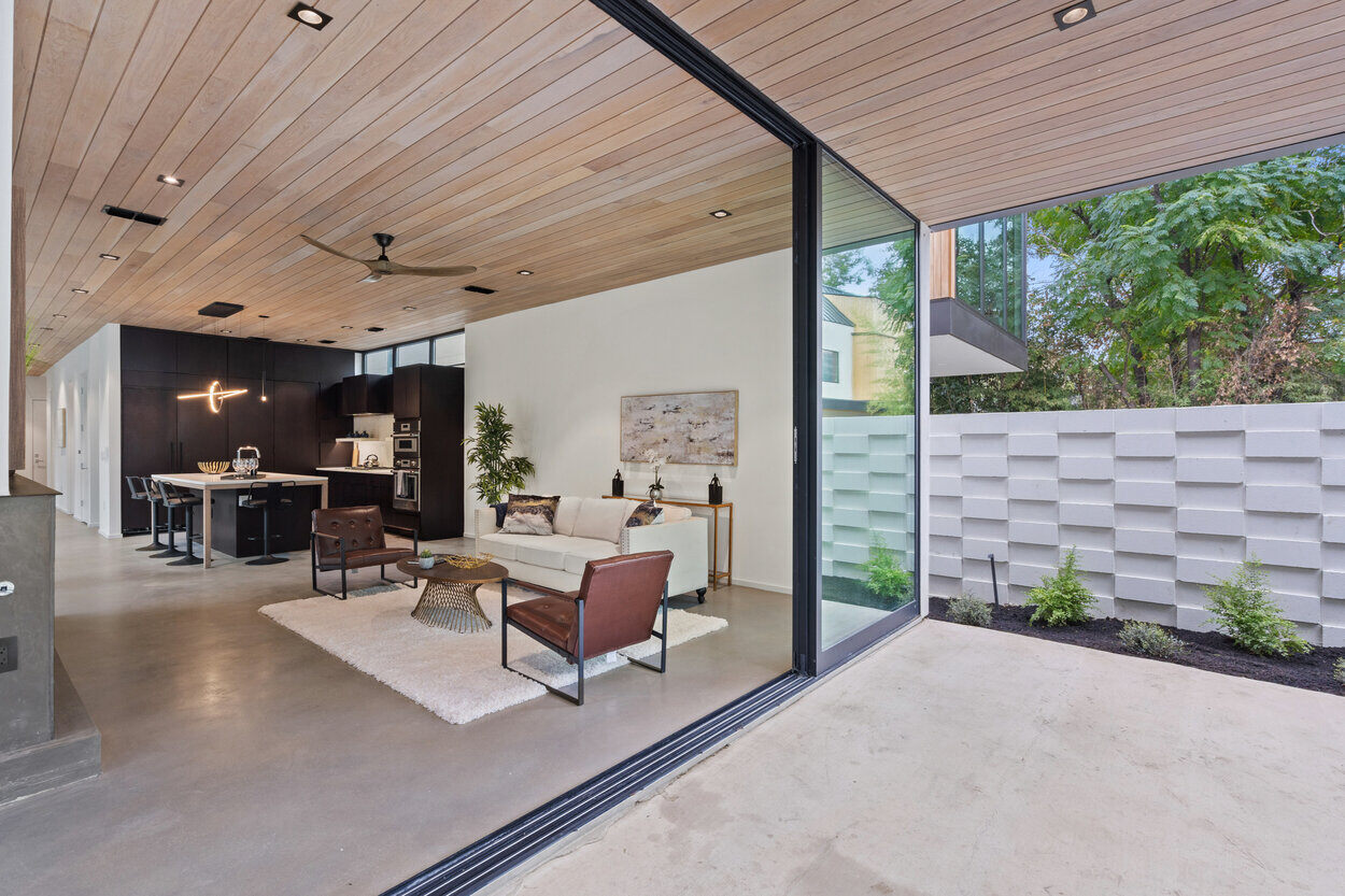 Seamless indoor-outdoor living space with sliding glass doors and modern decor in a custom home in Austin, TX by J. Angelo Design Build