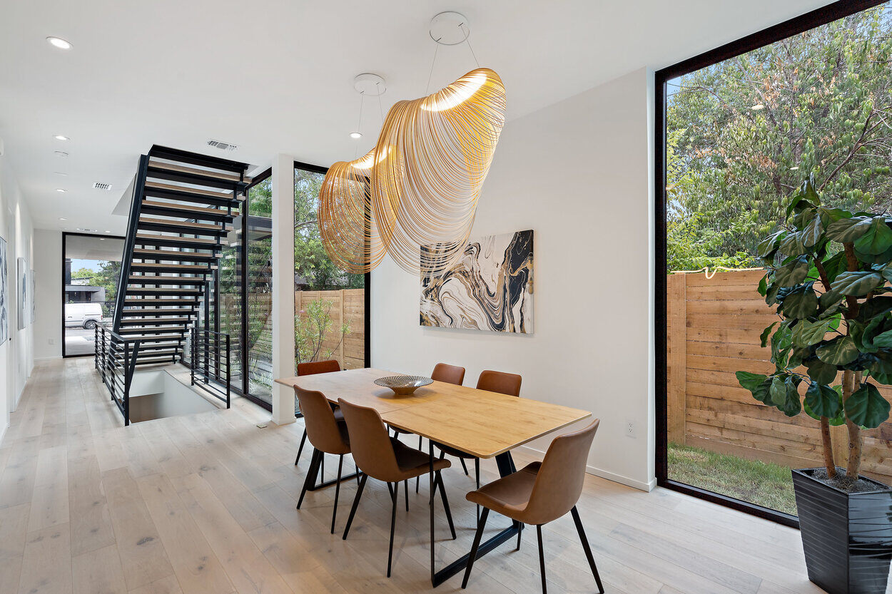 Custom home kitchen with dining area and statement chandelier by J. Angelo Design Build in Austin, TX