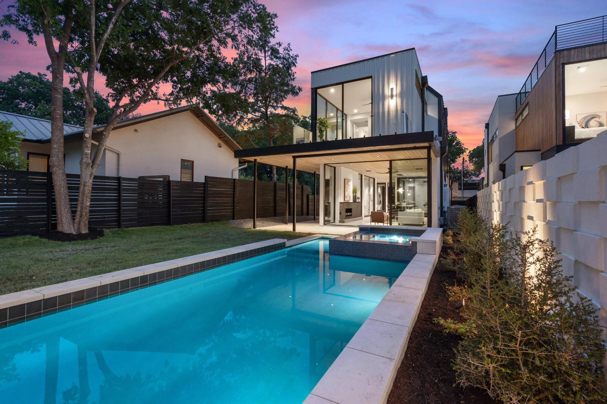 Backyard pool of custom home at dusk in Austin, TX by J. Angelo Design Build