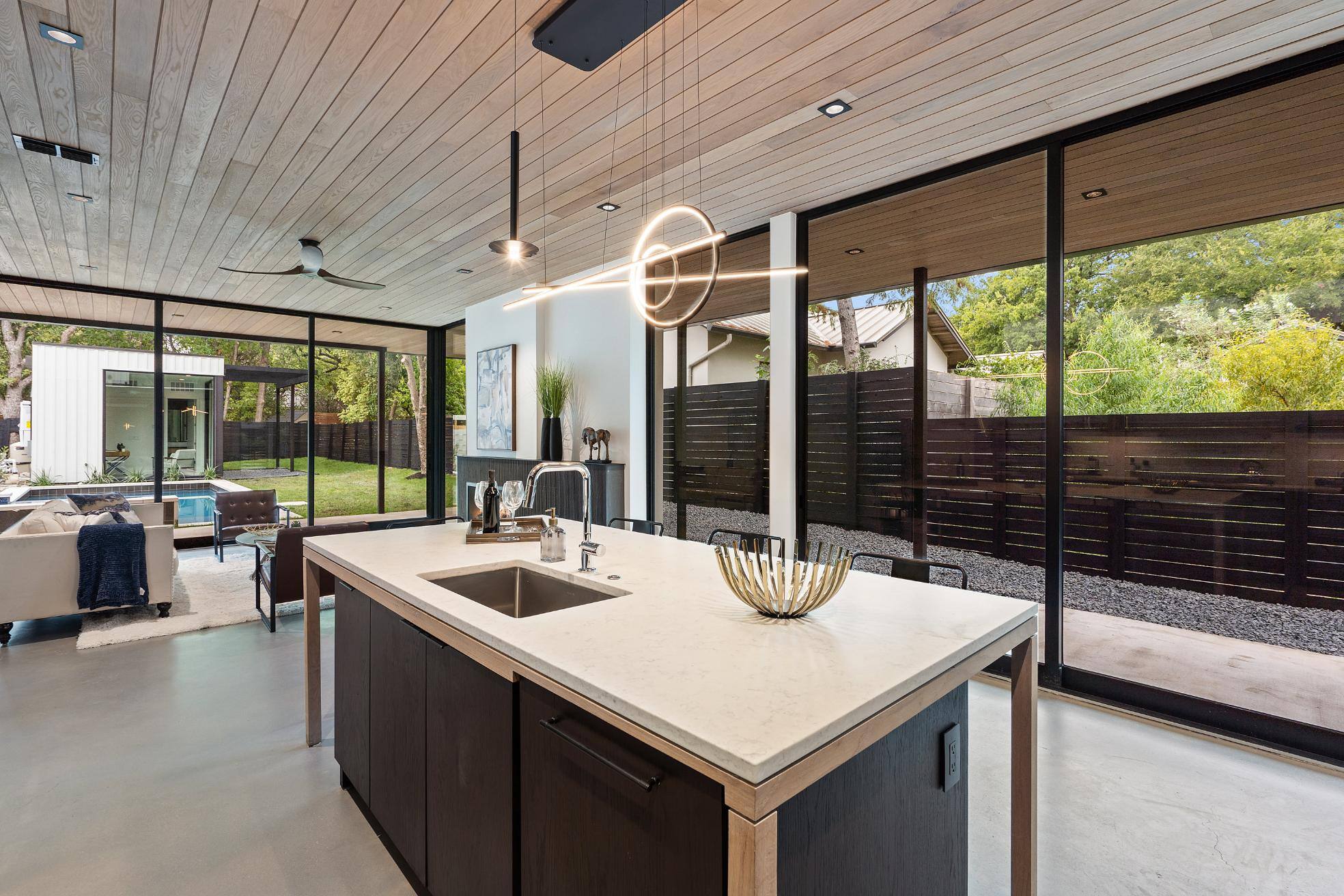 Custom kitchen with large windows and open floor plan by J. Angleo Design Build in Austin, TX